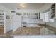 Updated kitchen featuring white cabinets, granite countertops, and modern appliances, creating an efficient cooking space at 120 S Olive --, Mesa, AZ 85204