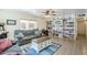Inviting living room featuring a comfortable sofa, shelving unit, and large window for natural light at 120 S Olive --, Mesa, AZ 85204