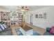 Spacious living room with a sofa, bookshelf, tile flooring, and view of backyard at 120 S Olive --, Mesa, AZ 85204