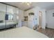 Open studio features a kitchenette, full-size mirror, and a bed with light yellow bedding at 120 S Olive --, Mesa, AZ 85204