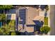 Aerial view of a home with a pool, basketball court, solar panels, and green lawn in the backyard at 1217 W Fever Tree Ave, San Tan Valley, AZ 85140