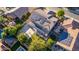 Aerial view of a home with a basketball court, solar panels, and green lawn in the backyard at 1217 W Fever Tree Ave, San Tan Valley, AZ 85140