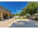 This is a well-lit backyard with a basketball court and covered patio at 1217 W Fever Tree Ave, San Tan Valley, AZ 85140