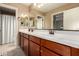Bathroom featuring double sinks with vanity, ample storage, and well-lit mirrors at 1217 W Fever Tree Ave, San Tan Valley, AZ 85140