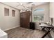A compact bedroom featuring a murphy bed, desk, and window for a comfortable living space at 1217 W Fever Tree Ave, San Tan Valley, AZ 85140