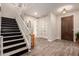 Inviting foyer with elegant tile flooring, a modern staircase, and a classic wooden front door at 1217 W Fever Tree Ave, San Tan Valley, AZ 85140