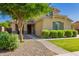Beautiful home with lush landscaping, including mature trees and manicured bushes, enhancing its curb appeal at 1217 W Fever Tree Ave, San Tan Valley, AZ 85140