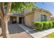 Charming home featuring manicured landscaping, decorative shrubbery, and a welcoming walkway to the front door at 1217 W Fever Tree Ave, San Tan Valley, AZ 85140