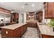 Gourmet kitchen with stainless steel appliances, granite countertops, and custom wood cabinets at 1217 W Fever Tree Ave, San Tan Valley, AZ 85140