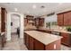 This well-lit kitchen boasts granite countertops, custom cabinets, and a large central island at 1217 W Fever Tree Ave, San Tan Valley, AZ 85140