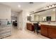 Spacious main bathroom with double vanity, large mirror, and a view into the walk-in closet at 1217 W Fever Tree Ave, San Tan Valley, AZ 85140