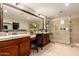 Luxurious main bathroom featuring a vanity, a large framed mirror, and a frameless glass shower at 1217 W Fever Tree Ave, San Tan Valley, AZ 85140