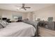 Serene main bedroom featuring wood-look floors, a ceiling fan, work space, and a gray furniture set at 1217 W Fever Tree Ave, San Tan Valley, AZ 85140