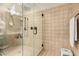 Bright frameless walk-in shower with tile surround, hand-held shower head, and built-in shower bench at 1217 W Fever Tree Ave, San Tan Valley, AZ 85140