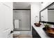 Modern bathroom featuring dual copper vessel sinks, black cabinets, and sleek fixtures at 12271 N 74Th St, Scottsdale, AZ 85260