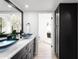 Modern bathroom featuring dual blue vessel sinks, black cabinets, and sleek fixtures at 12271 N 74Th St, Scottsdale, AZ 85260