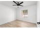 Clean bedroom with light wood floors, a ceiling fan, and a view from the window at 12271 N 74Th St, Scottsdale, AZ 85260