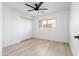 Clean bedroom with light wood floors, a ceiling fan, and a double-door closet at 12271 N 74Th St, Scottsdale, AZ 85260