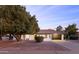 Charming single-story home featuring a well-manicured yard and a modern garage door at 12271 N 74Th St, Scottsdale, AZ 85260