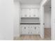 Hallway with built-in white cabinets and black countertop at 12271 N 74Th St, Scottsdale, AZ 85260