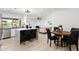 Open-concept kitchen with modern appliances and seating at the island, flows into the dining area at 12271 N 74Th St, Scottsdale, AZ 85260