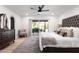 Comfortable bedroom with a king-size bed, backyard views, and a ceiling fan at 12271 N 74Th St, Scottsdale, AZ 85260