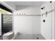 Contemporary shower room with sleek tile, black fixtures and a glass door at 12271 N 74Th St, Scottsdale, AZ 85260
