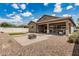 Expansive backyard featuring gravel landscaping, a cozy fire pit area, and a covered patio at 1228 W Snowbell Ave, Queen Creek, AZ 85140