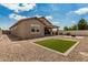 Large backyard with gravel landscaping, a small artificial grass area, and a covered patio at 1228 W Snowbell Ave, Queen Creek, AZ 85140