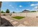 Spacious backyard with gravel, brick paver pathways, an artificial grass area, and block wall fencing at 1228 W Snowbell Ave, Queen Creek, AZ 85140