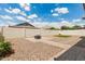 Expansive backyard featuring gravel landscaping, a fire pit area, brick paver walkways, and block wall fencing at 1228 W Snowbell Ave, Queen Creek, AZ 85140