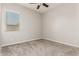 Bedroom featuring neutral walls, carpet, ceiling fan, and a bright window at 1228 W Snowbell Ave, Queen Creek, AZ 85140