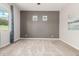 Empty bedroom with neutral walls, gray accent wall, and carpeted floors at 1228 W Snowbell Ave, Queen Creek, AZ 85140