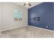 Cozy bedroom with accent wall, mounted shelves, ceiling fan, and window at 1228 W Snowbell Ave, Queen Creek, AZ 85140