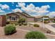 Attractive single level home with neutral exterior, lush landscaping, and two car garage at 1228 W Snowbell Ave, Queen Creek, AZ 85140