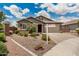 Charming single story house featuring well maintained landscaping and a cozy entryway at 1228 W Snowbell Ave, Queen Creek, AZ 85140