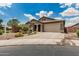 Beautiful single story home with a brick driveway and stone pillars at 1228 W Snowbell Ave, Queen Creek, AZ 85140