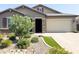 Inviting single-story home featuring a well-manicured front yard and a brick driveway at 1228 W Snowbell Ave, Queen Creek, AZ 85140