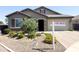 Charming single-story home with a well-maintained landscape, desert rock, and a For Sale sign at 1228 W Snowbell Ave, Queen Creek, AZ 85140