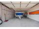 Spacious garage featuring epoxy floors, built-in cabinets, and ample storage for vehicles and equipment at 1228 W Snowbell Ave, Queen Creek, AZ 85140