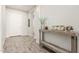 Inviting hallway featuring wood-look tile flooring and decorative table at 1228 W Snowbell Ave, Queen Creek, AZ 85140