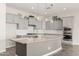 Well-lit kitchen with gray cabinets, a large island and stainless steel appliances at 1228 W Snowbell Ave, Queen Creek, AZ 85140