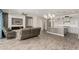 Open concept living room showcasing tile flooring, modern fireplace, and adjacent kitchen at 1228 W Snowbell Ave, Queen Creek, AZ 85140