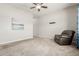 Spacious living room with neutral-colored walls and carpeted floors at 1228 W Snowbell Ave, Queen Creek, AZ 85140