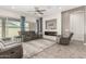 Comfortable living room featuring tile floors, modern fireplace, and sliding glass doors at 1228 W Snowbell Ave, Queen Creek, AZ 85140