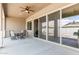 Covered patio with ceiling fan, large sliding glass doors, and outdoor seating area at 1228 W Snowbell Ave, Queen Creek, AZ 85140
