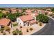 Beautiful aerial view of a two-story home featuring a red-tile roof, mature trees, desert landscaping, and an attached garage at 12748 N 57Th Dr, Glendale, AZ 85304