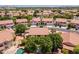 An upscale residential neighborhood with red-tile roofs, mature trees, and manicured lawns under a clear, sunny sky at 12748 N 57Th Dr, Glendale, AZ 85304