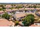 A large, landscaped backyard with a sparkling pool, paved patio, and lush landscaping under a clear, blue sky at 12748 N 57Th Dr, Glendale, AZ 85304