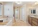 Bright bathroom with a soaking tub and granite countertops at 12748 N 57Th Dr, Glendale, AZ 85304